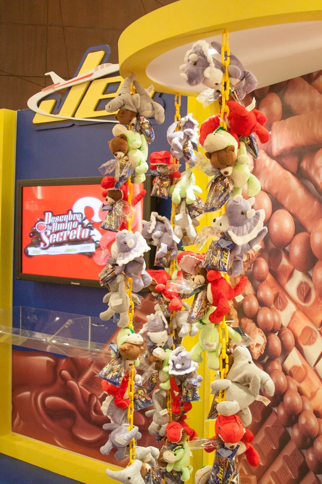 Detalle del stand de Jet con peluches colgados y pantalla